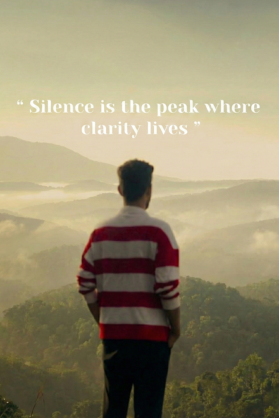 Finding clarity in silence and nature A man standing quietly on a hilltop overlooking misty green mountains, reflecting in silence and nature