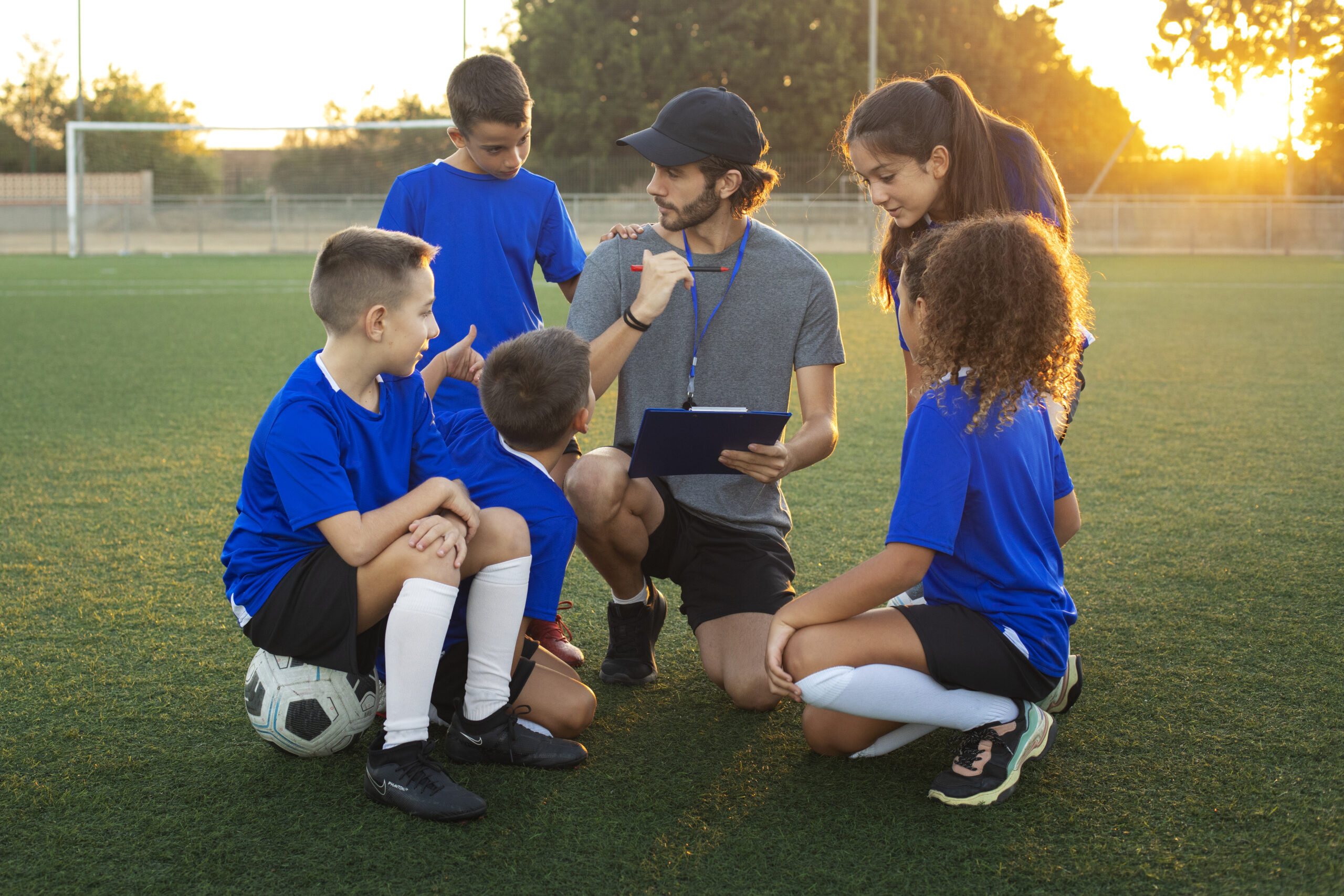 football-trainer-teaching-children-front-view